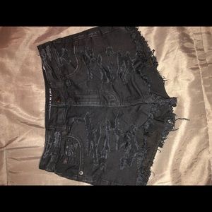 Distressed black jean shorts.